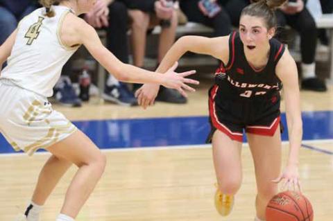 Ellsworth’s Elyse Haxton, right, looks for an opening around Sacred Heart’s Skylar Douglas Jan. 17 in Salina. The Bearcats defeated the Knights 54-51. KAREN BONAR/Ellsworth County Independent-Reporter