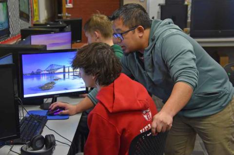 Instructor Jason Maisog assists junior Kyle Keller in the computer lab at Ellsworth Jr./Sr. High School. Maisog’s hands-on style has students making connections in the community to solve real-life problems. CATHERINE DOUD/Ellsworth County Independent-Re