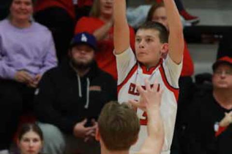 Ellsworth freshman Coulson Barta goes for 3 points over Republic County’s Grady Siemsen. KAREN BONAR/Ellsworth County Independent-Reporter