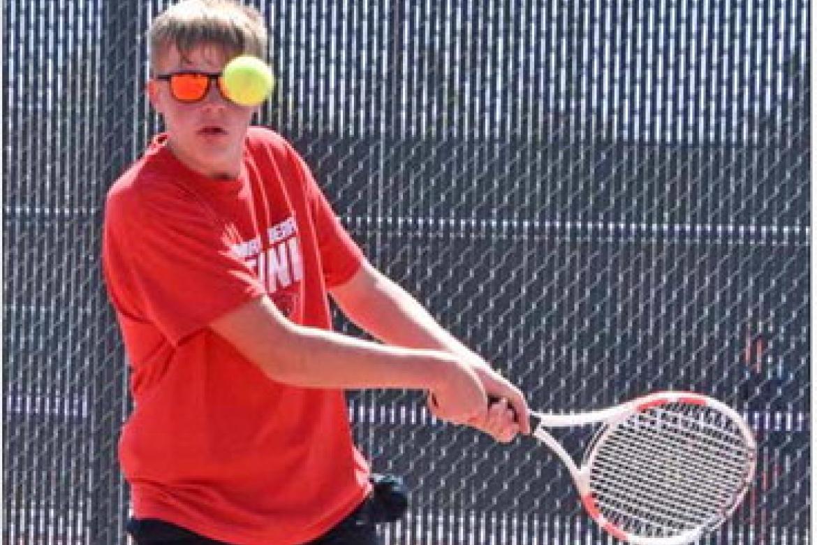 Freshman Owen Schultz keeps his eye on the ball during the season opener home tennis tournament April 2. CATHERINE DOUD/Ellsworth County Independent-Reporter